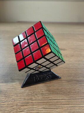 Rubik's 4x4 Master Cube Puzzle Game with Black Triangular Display Stand Set